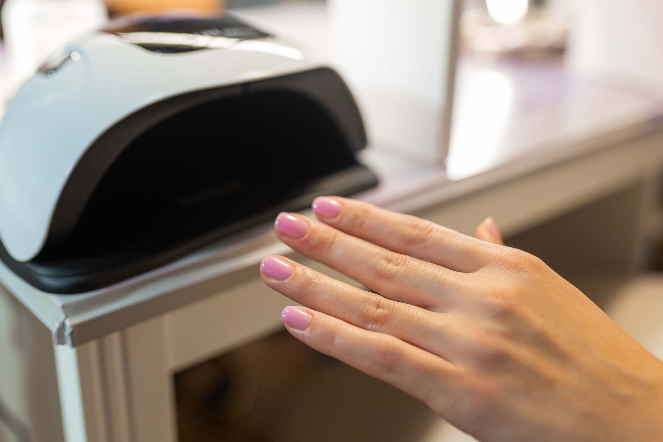 Close up of female hand curing gel nail polish GEL POLISH - Image 1